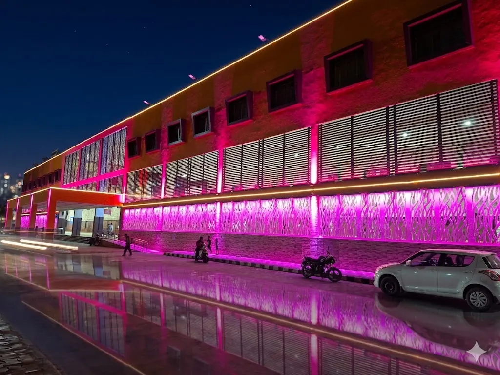 Mehsana railway station facade lit in magenta at night