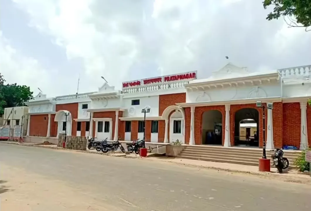 Pratapnagar railway station building lit at dusk